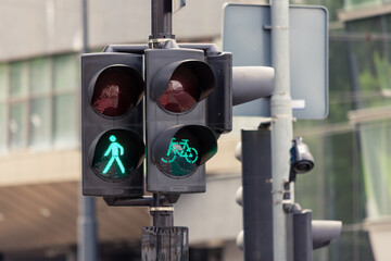 Pedestrian and bicycle semaphores on green light to allow people and bikers to cross the...