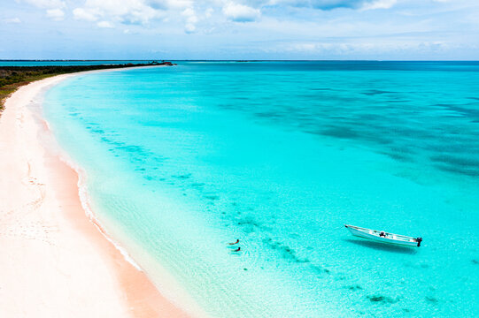 Mother And Son Swimming In The Crystal Sea Next To A Pink Sand Beach, Aerial View, Barbuda, Antigua And Barbuda, West Indies, Caribbean