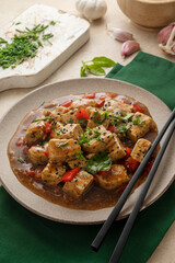 Stir fried Tofu in with sesame and fresh herbs. Homemade healthy vegan meal - fried tofu.