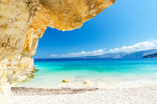 Crystal sea surrounded by limestone cliffs and white pebbles, Fteri Beach, Kefalonia, Ionian Islands, Greek Islands, Greece