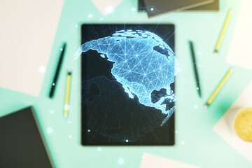 Double exposure of digital America map and digital tablet on background, top view, research and strategy concept