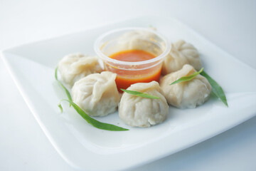 close up of chicken momo dumpling on a plate 