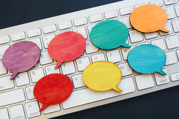 Keyboard and speech bubbles as symbol of rumors and controversy.