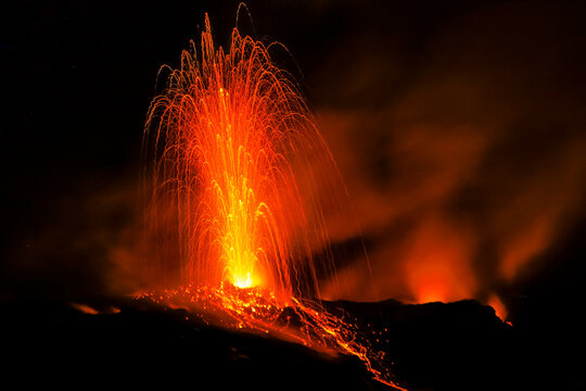 Lava bombs erupt from one of many vents on volcano, active for at least 2000 years, Stromboli, Aeolian Islands, UNESCO World Heritage Site, Sicily, Italy