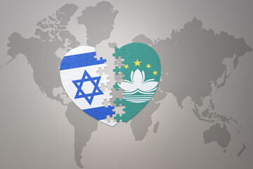 puzzle heart with the national flag of Macau and israel on a world map background.Concept.