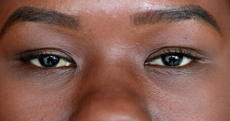 Mixed race black woman opening eyes looking at camera