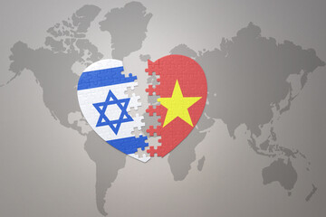 puzzle heart with the national flag of vietnam and israel on a world map background.Concept.
