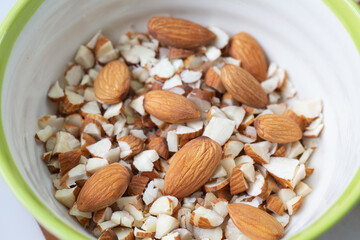 Dry almond and almond slice on ceramic cup.