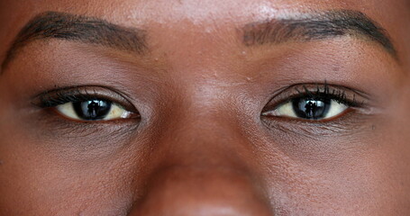 Meditative young black woman closing eyes in contemplation. Macro close-up woman eye
