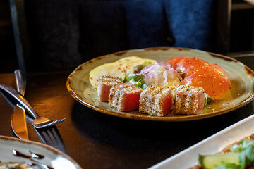 Seared ahi tuna with sesame seeds and soy sauce, wasabi, macro shot of sesame on tuna.