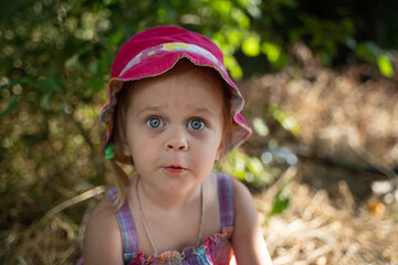 Baby girl plays in nature