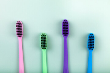 Multicolored toothbrushes on a green background.