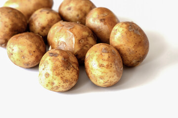 Heap of young potatos isolated on white background