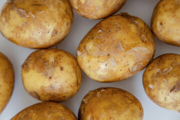 Heap of young potatos isolated on white background