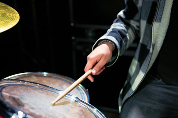 Close-up of a drummer's hand with sticks