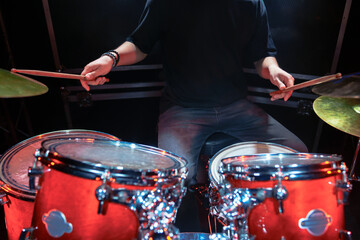 Close-up of male hands playing the drums