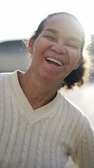 A happy latin senior woman smiling at camera. Portrait of a Brazilian south american person