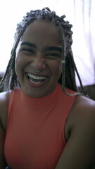 A happy black woman smiling at camera with Box Braids hairstyle portrait of a Brazilian person