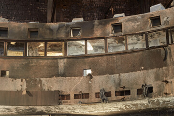 Fototapeta premium Abandoned ruined interior of the building. Old destroyed walls with garbage and dirt. 