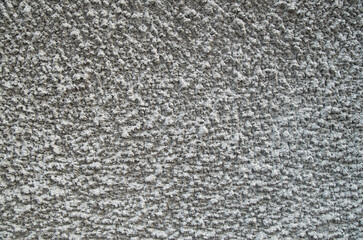 Old gray relief cement plaster on wall close