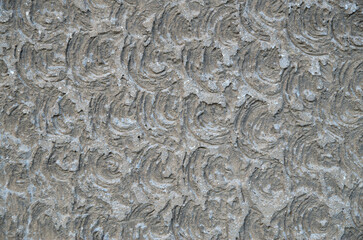 Old gray relief cement plaster on wall close