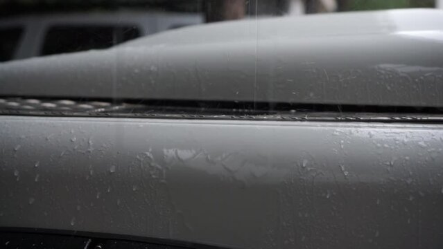 Raining over SUV in a cloudy day