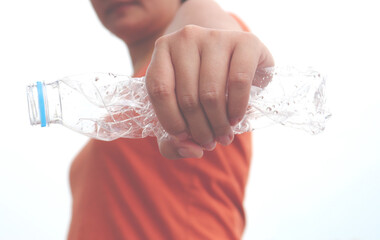 The concept of stop plastic, recycling. Woman hand holding a crumpled plastic bottle. vintage style