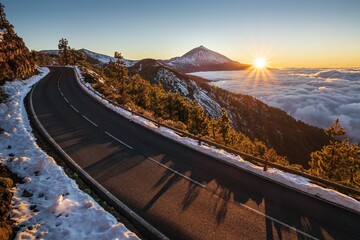 Beautiful view of the road surrounded by snow volcano on the Teide volcano background