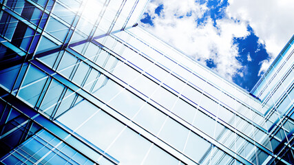 Obraz premium Glass building. Transparent glass wall of office building. Modern office building with glass facade on a clear sky background. 3d Rendering