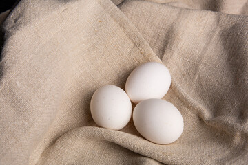 Chicken white eggs on burlap. Farm products. Natural eggs. Chicken eggs on the table.