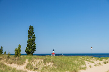 Sand beach and beachgrass with St. Joseph North Pier Inner Lighthouse and St. Joseph North Pierhead...