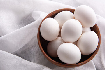 Chicken white eggs on burlap. Farm products. Natural eggs. Chicken eggs on the table.