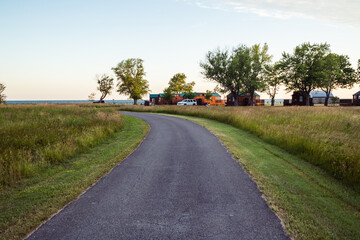 Beautiful sunrise background near Lake Erie in Ohio. Pathway into the Geneva-On-The-Lake campgrounds. - obrazy, fototapety, plakaty