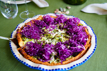 quiche pie with cauliflower, cod, on the decor purple cabbage with olive oil. 