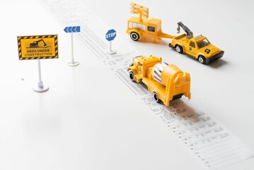Closeup shot of a playing set of construction cars and equipment isolated on the white table