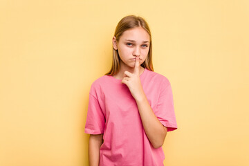 Young caucasian girl isolated on yellow background thinking and looking up, being reflective, contemplating, having a fantasy.