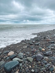 Wet sea pebbles and waves