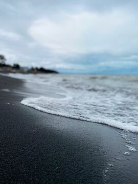 Small waves on black sand beach