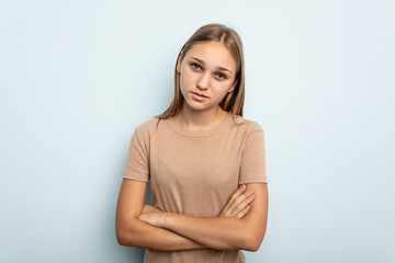 Fototapeta premium Young caucasian girl isolated on blue background who is bored, fatigued and need a relax day.