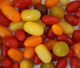Full frame background of assorted red orange and yellow tomatoes