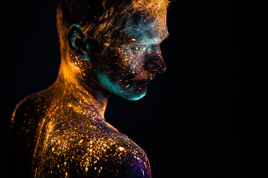 Portrait of a man painted in fluorescent UV colors.