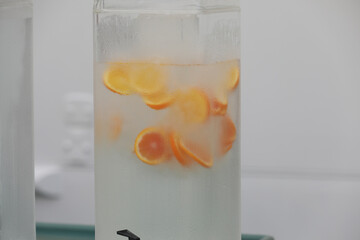 Refreshing transparent tanks with cold water and different flavors as lemon, orange for Cruise ship...