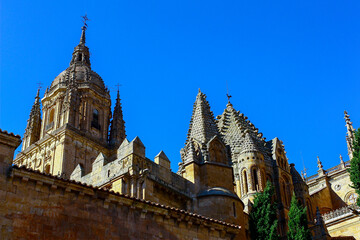 Short view of the tower of the cathedral in Salamanca, Spain, on a sunny day with a bright blue sky