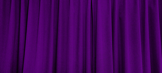 close up view of dark purple curtain in thin and thick vertical folds made of black out sackcloth...