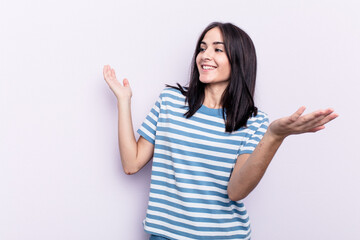 Young caucasian woman isolated on pink background joyful laughing a lot. Happiness concept.