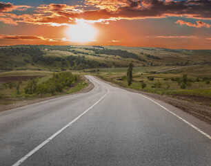 Country asphalt road at sunset