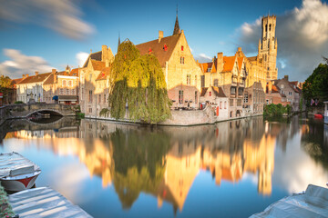 Rozenhoedkaai canal reflection at sunrise and blurred clouds, Bruges