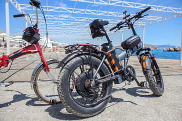Fototapeta na wymiar Electric bikes on the beach by the sea
