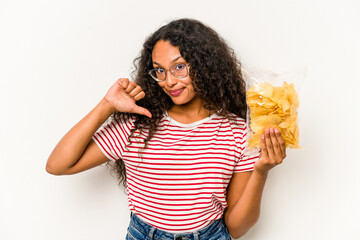 Young hispanic woman holding crips isolated on white background feels proud and self confident, example to follow.