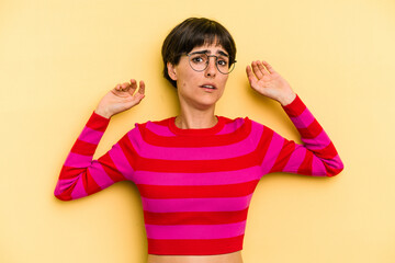 Young caucasian woman with a short hair cut isolated being shocked due to an imminent danger